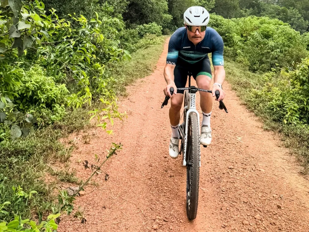 Why is F1 star Valtteri Bottas riding his bicycle from Malaysia to Singapore GP?