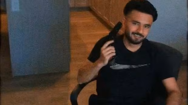 Alleged Bishnoi associate flaunts guns, bullets, cash in video obtained by CBC News