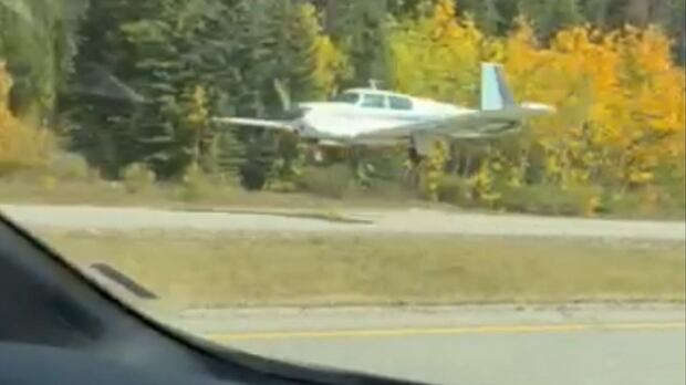 Plane lands on Highway 1 in Banff National Park